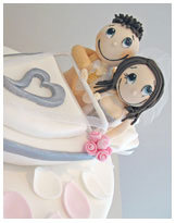 funky couple in boat wedding cake